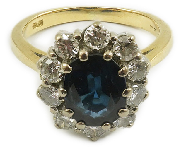 A modern 18ct gold, sapphire and diamond set oval cluster ring